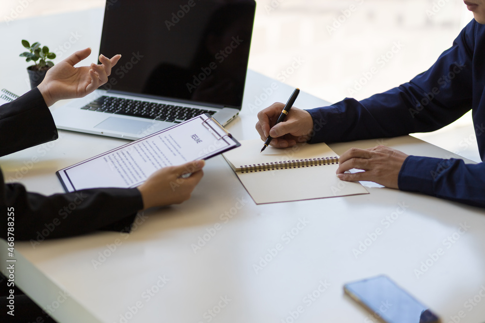 Two businessmen discussing and exchanging ideas in the office. Businesswoman holding resume doing jo