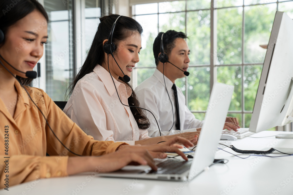 Business people wearing headset working actively in office . Call center, telemarketing, customer su