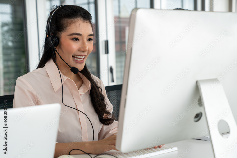 Businesswoman wearing headset working actively in office . Call center, telemarketing, customer supp