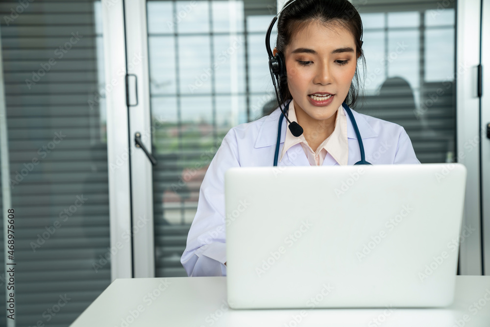 Doctor wearing headset talking actively on video call in hospital or clinic . Concept of telehealth 