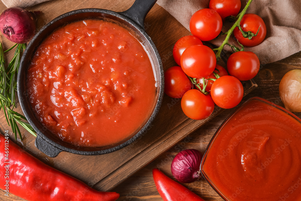 Organic tomato sauce on wooden background