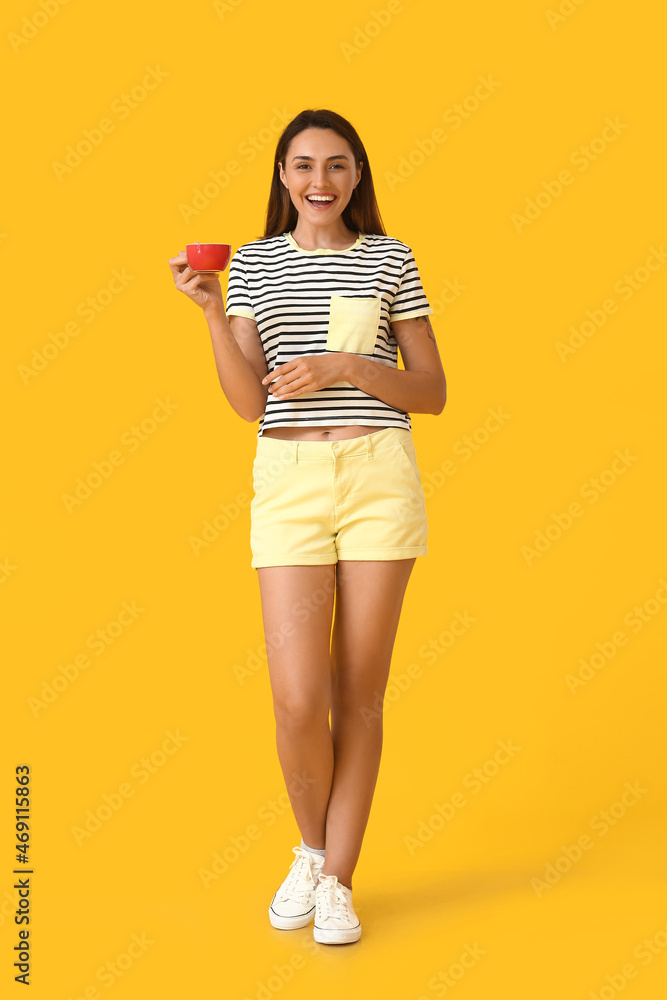 Beautiful woman with cup of coffee on color background