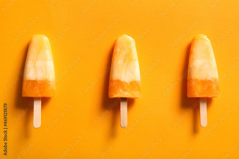 Tasty melon popsicles on color background