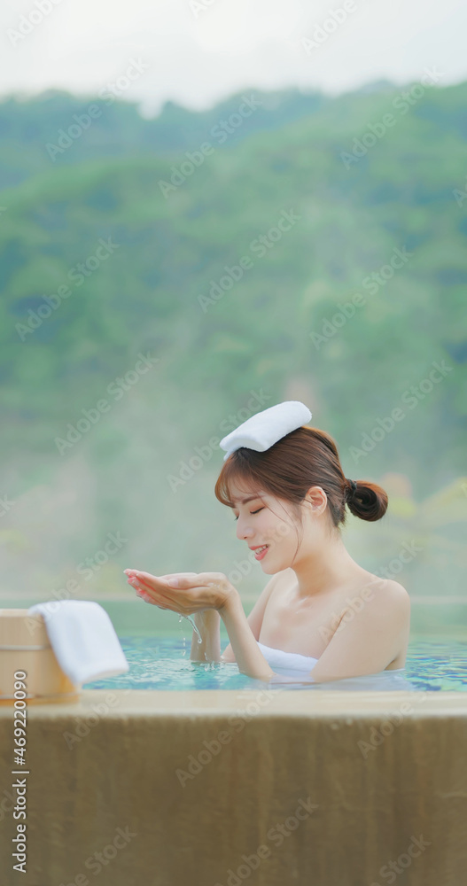 Woman scoop up hot spring