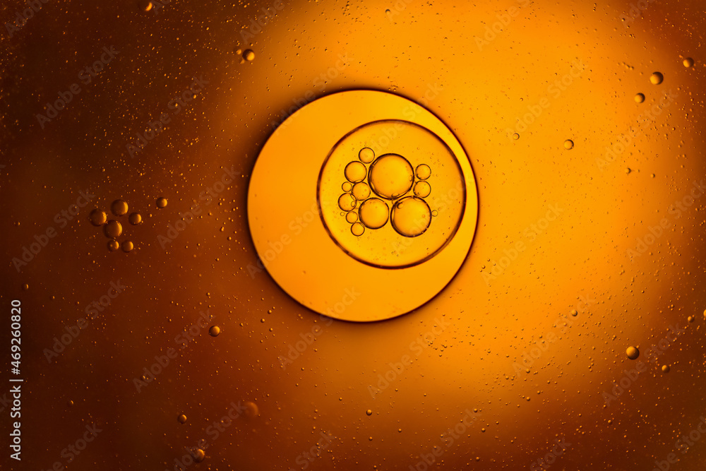 Abstract bubbles vegetable oil and water on yellow background