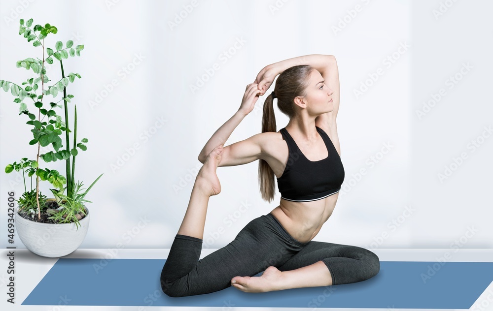 Happy woman wearing sportwear doing Yoga exercise,