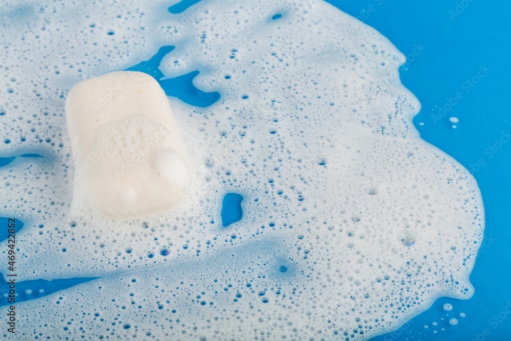 Bar of colored Soap on white bubbles