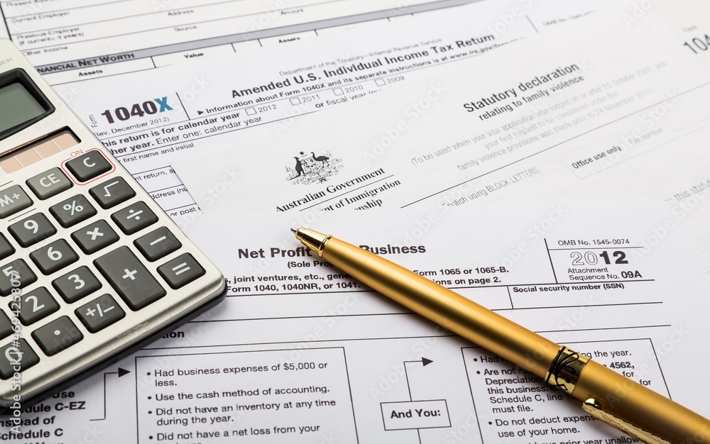 Calculator and Pen on Tax Documents