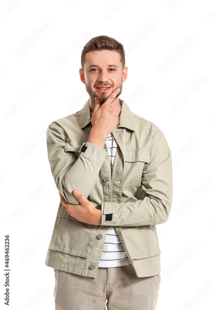 Thoughtful young man in stylish jacket on white background