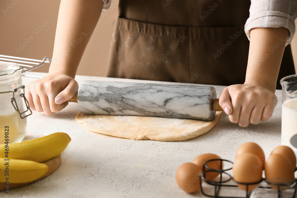 Woman preparing dough for homemade cookies at kitchen table, closeup