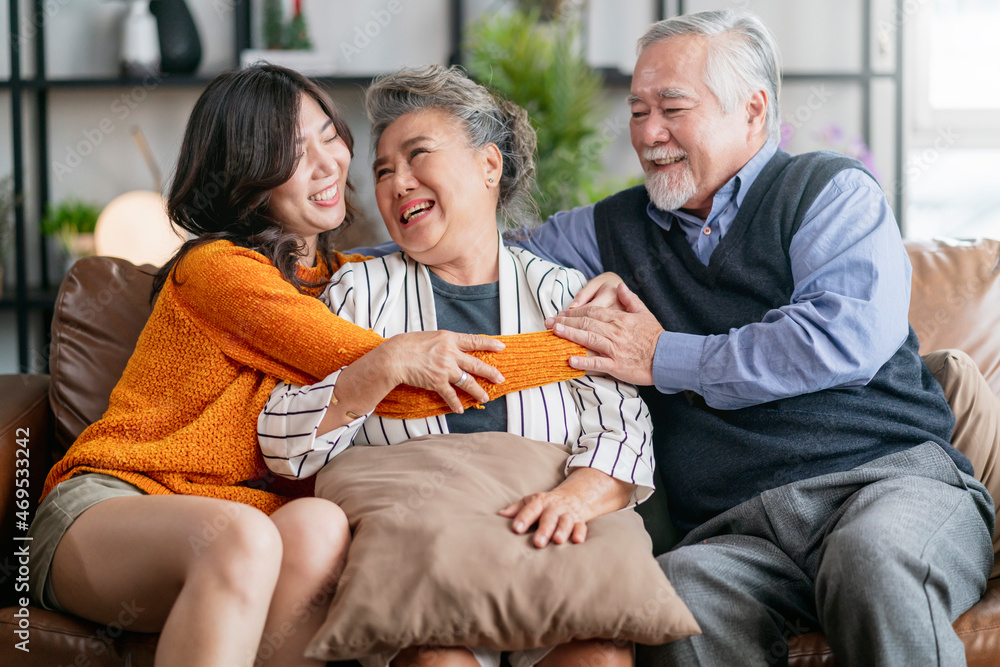 happiness asian family candid of daughter hug grandparent mother farther senior elder cozy relax on 