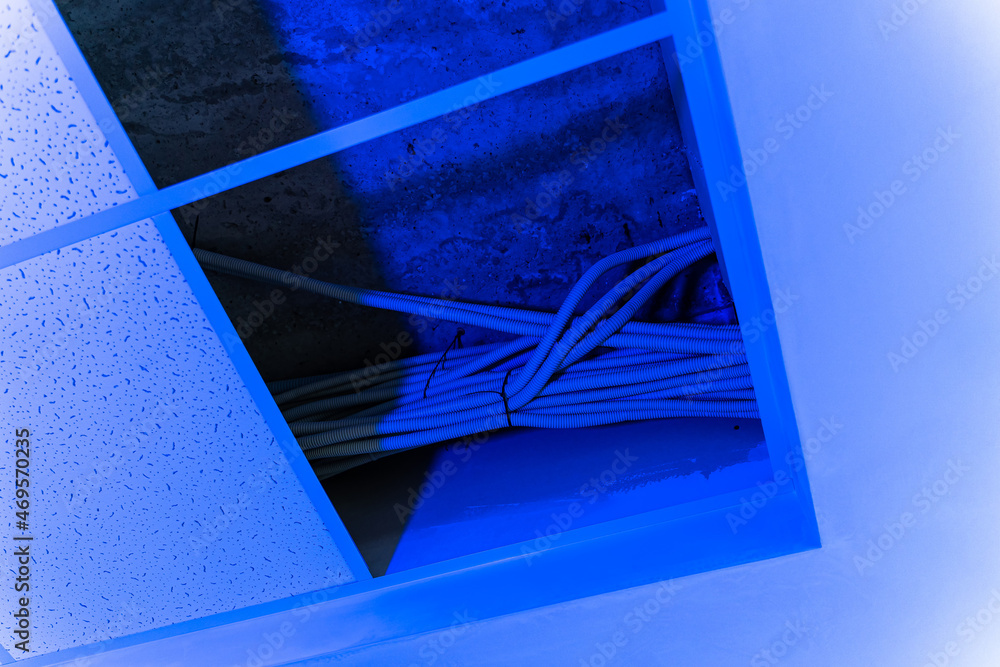 Newly repaired interior in white colors. Plasterboard ceiling. Empty room. Neon light. Closeup view