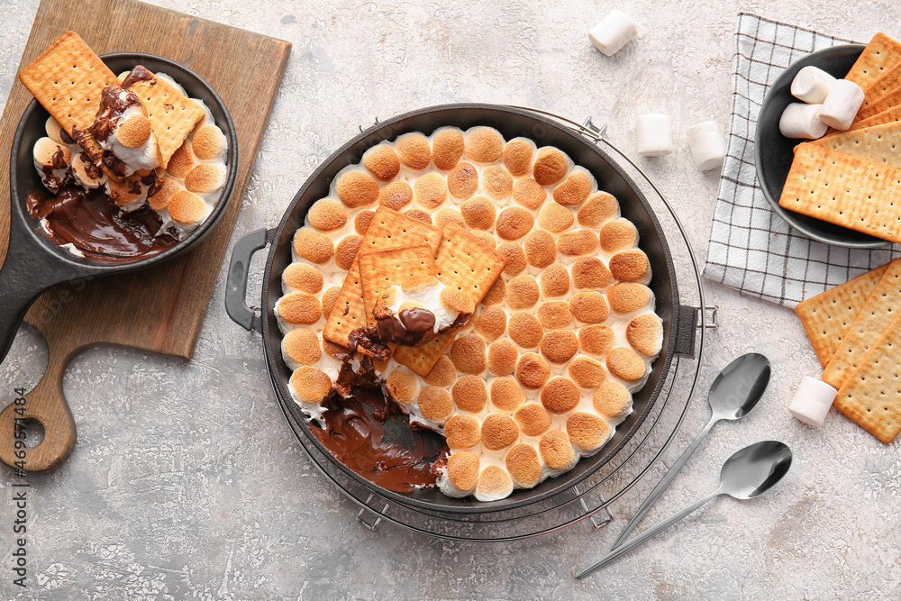 Composition with tasty Smores dip on grey background