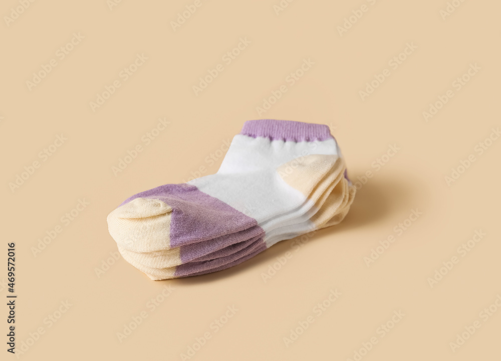 Stack of cotton socks on color background