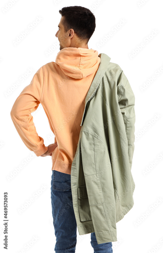 Young man in hoodie and jacket on white background