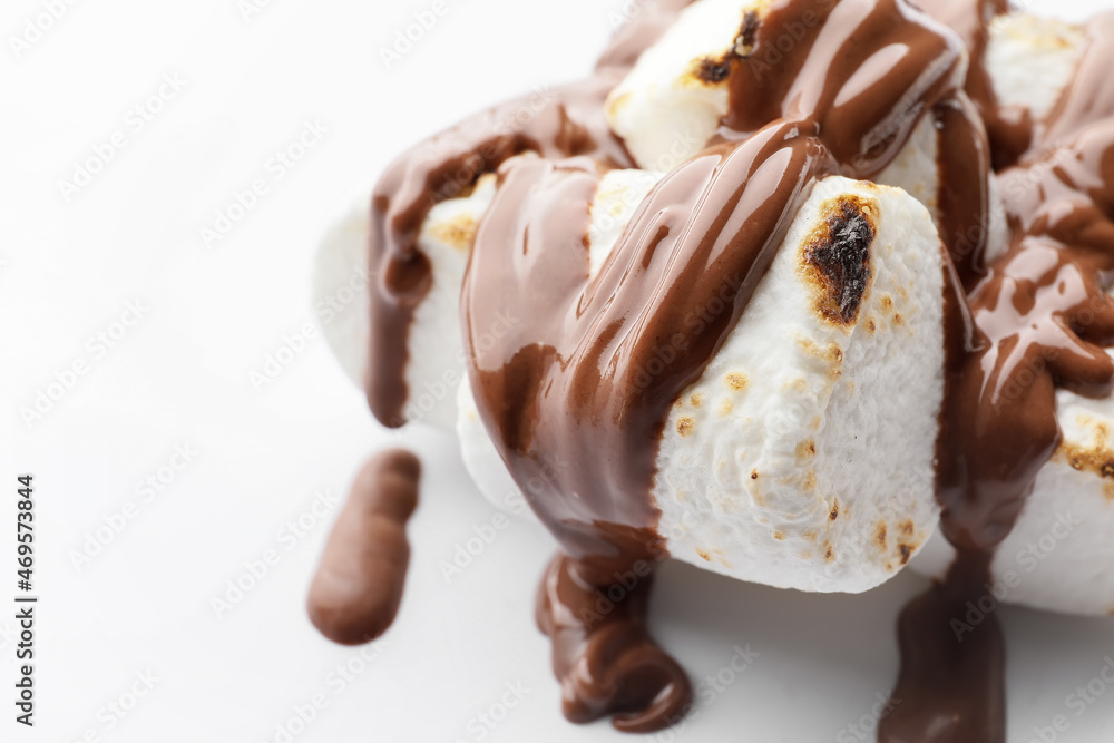 Tasty grilled marshmallows in chocolate on white background