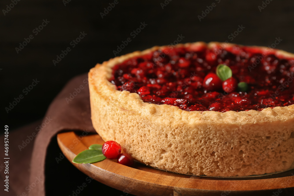 Stand with tasty lingonberry pie on table, closeup