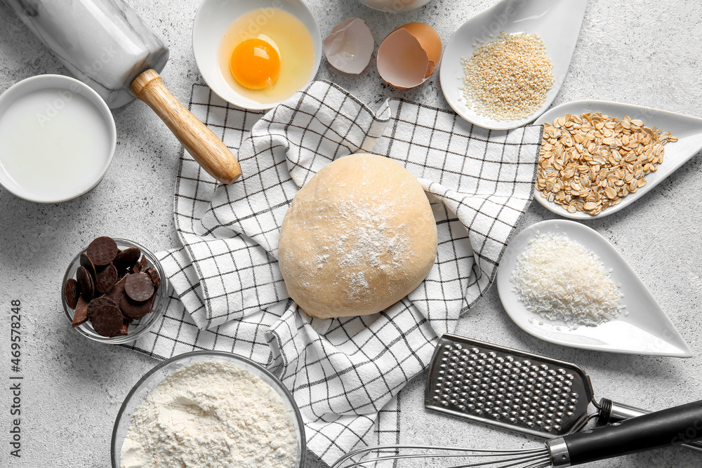 Fresh dough and ingredients for preparing homemade cookies on light background