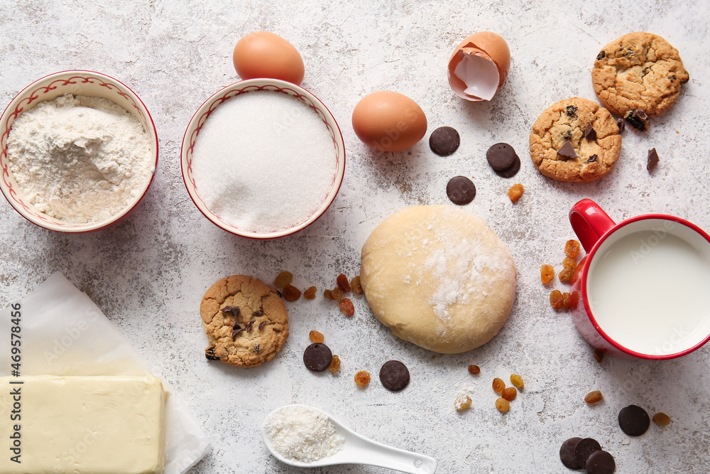 Fresh dough and ingredients for preparing homemade cookies on light background