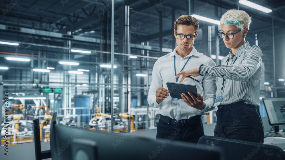 Male Engineer and Female Industrial Product Designer Discuss Work while Standing in Office at a Car 