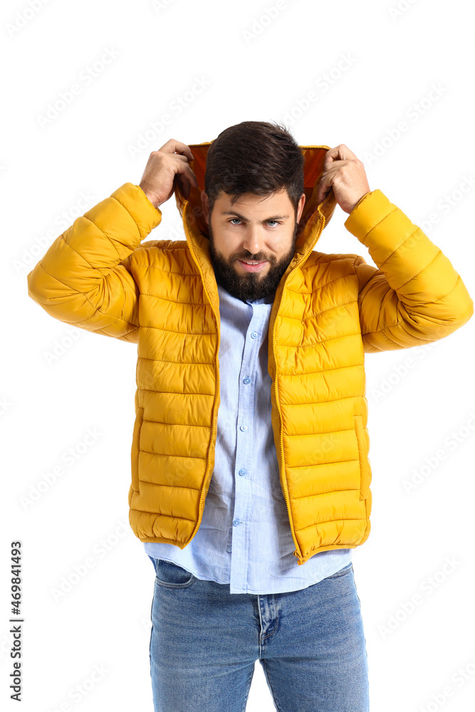 Handsome man in bright yellow jacket on white background