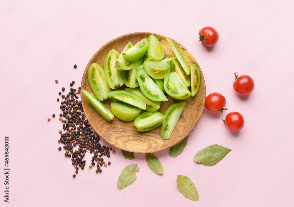 Plate with ingredients for preparing canned tomatoes on color background