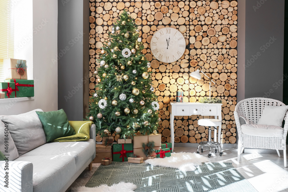 Interior of living room with beautiful Christmas tree and modern workplace