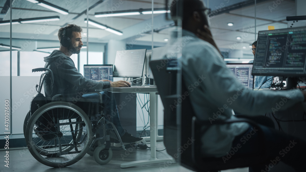 Disability-Friendly Office: Amazing IT Programmer with Disability in a Wheelchair Working on Desktop