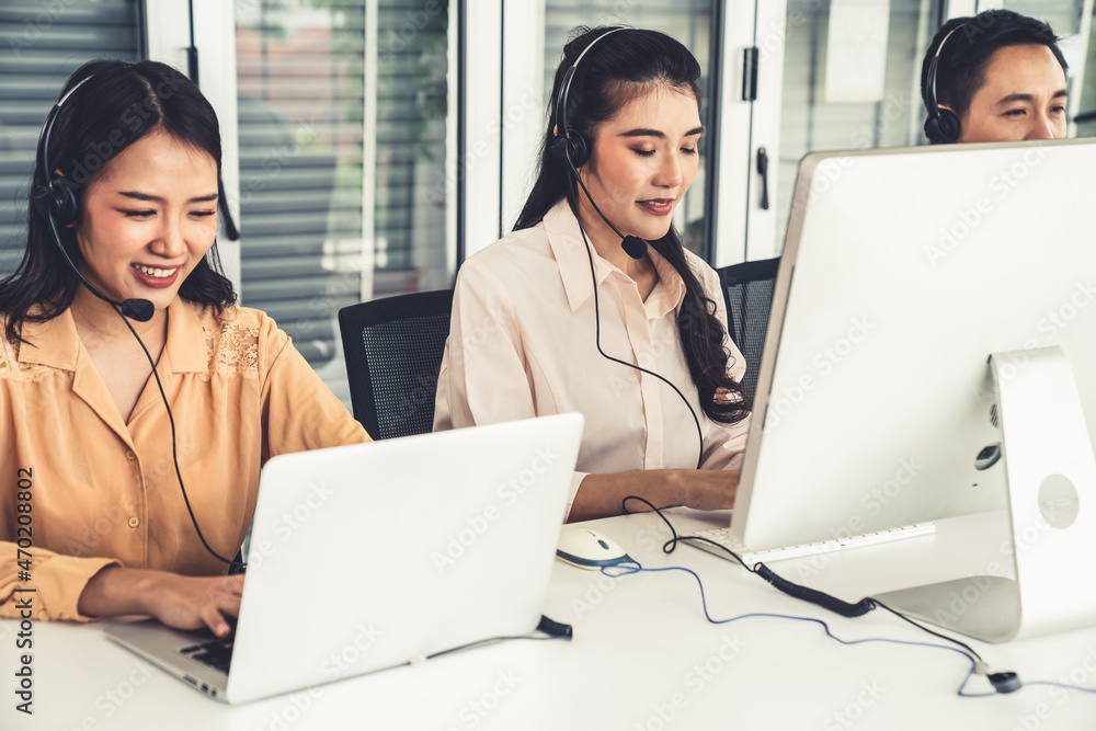 Business people wearing headset working actively in office . Call center, telemarketing, customer su