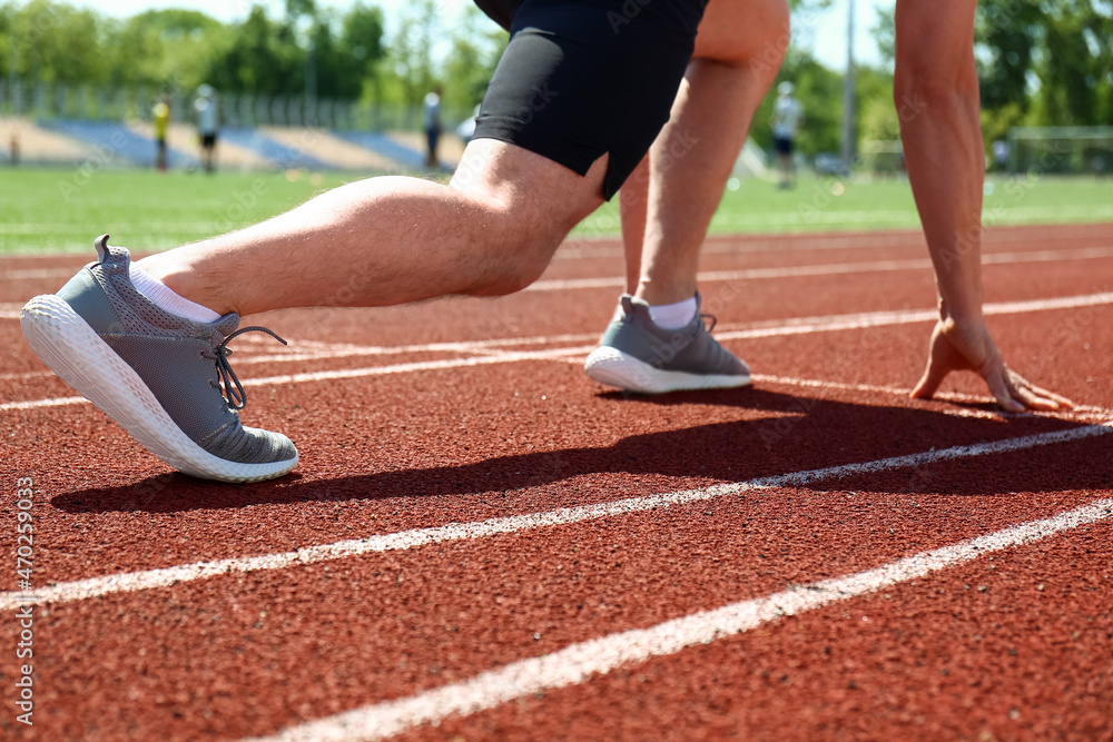 Athlete in starting position in stadium