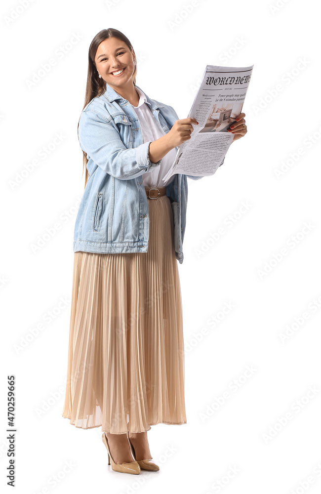 Young woman in denim jacket reading newspaper on white background