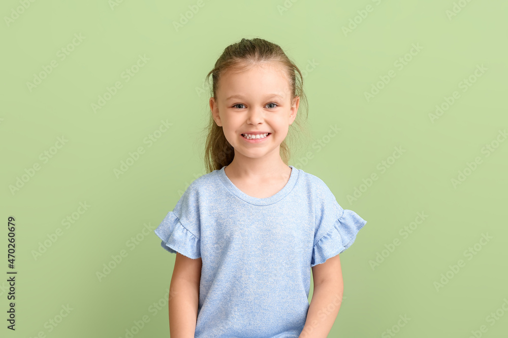 Portrait of happy little girl on color background