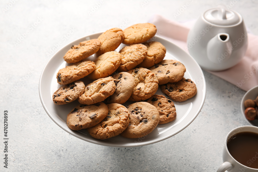 Stand with tasty homemade cookies on light background