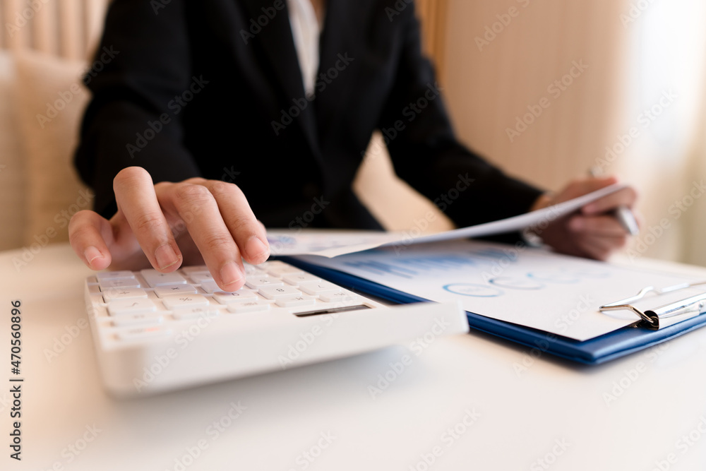 Close up of accountant or banker checking investment results, calculates financial savings, calculat