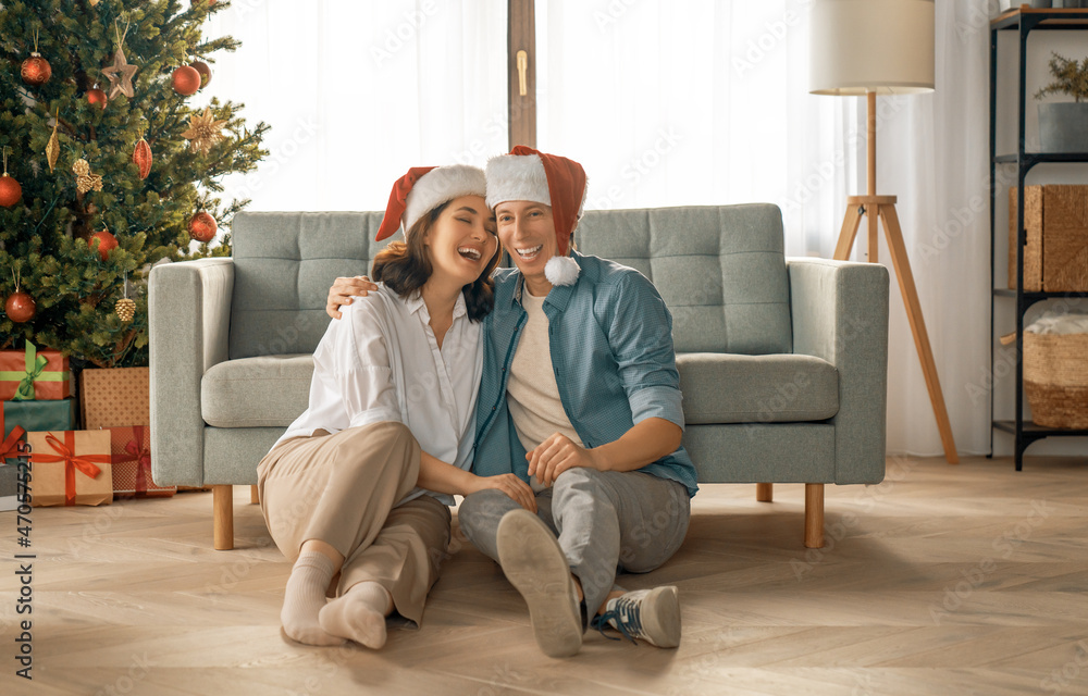 couple relaxing near Christmas tree