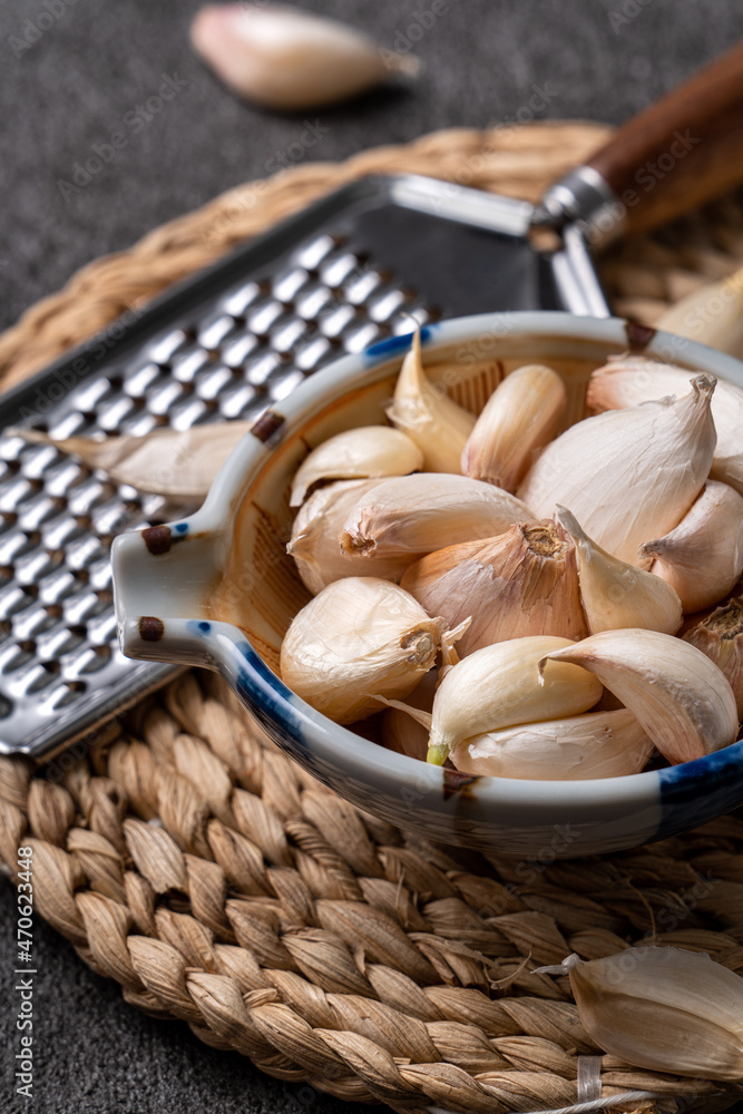 Fresh garlic cloves on black table background.