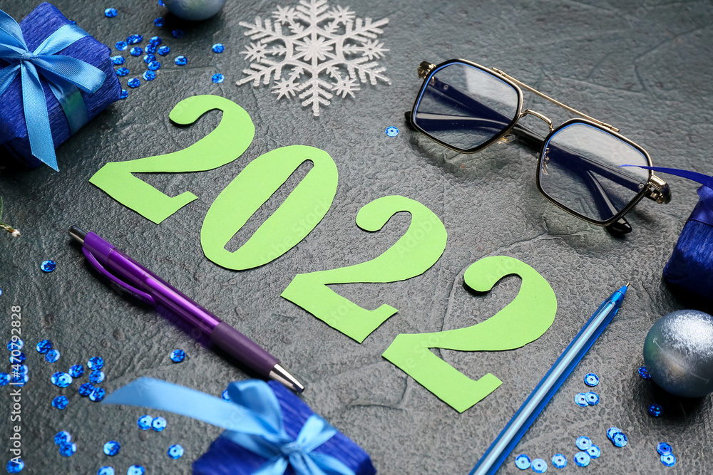 Figure 2022 with office supplies and decor on dark background