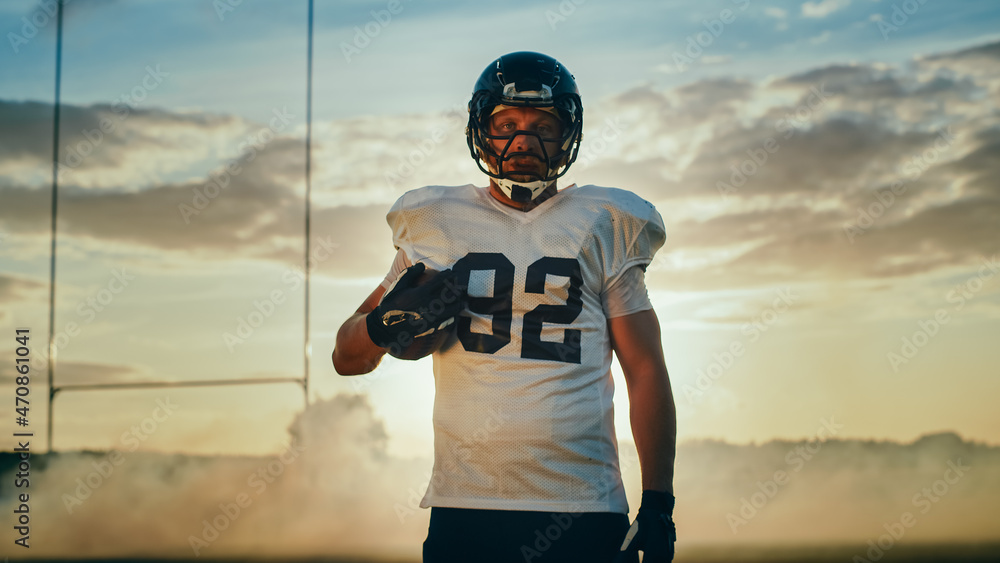 American Football Championship Game: Portrait of a Muscular Player Wearing Helmet and Holding Ball. 