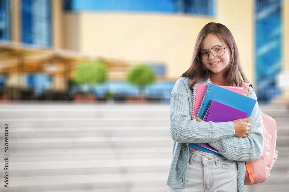 快乐快乐的女少年背着背包准备上学的概念