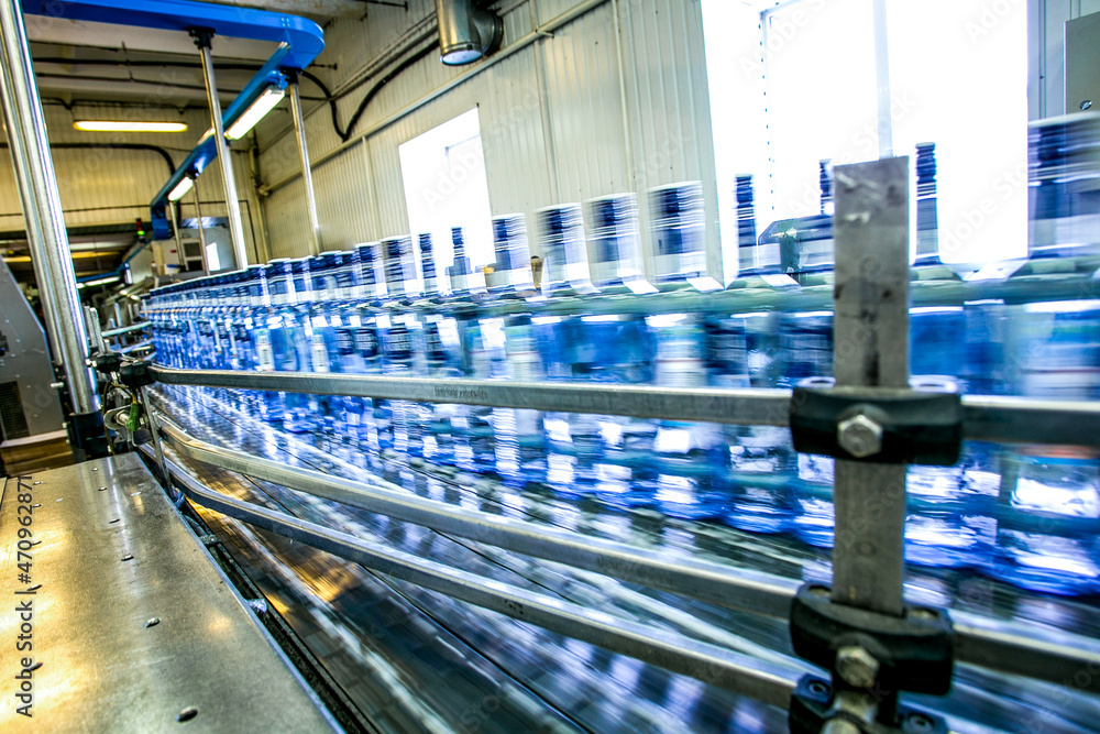 Many bottles of alcohol drink in factory on conveyor belt 