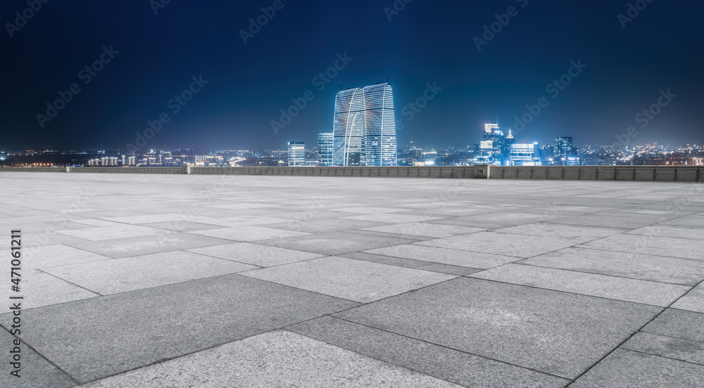 Empty brick floor with city skyline background