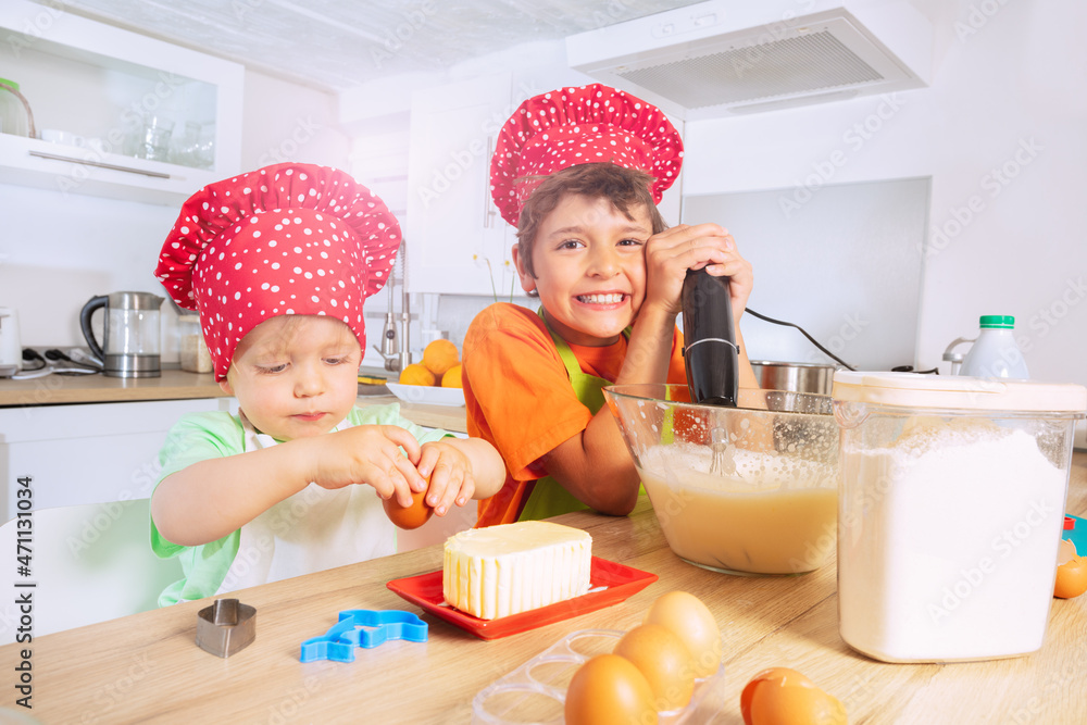 Boy mix dough in bowl make cookies with brother