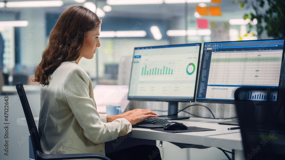 Young Confident Businesswoman Using Desktop Computer in Modern Office with Colleagues. Stylish Beaut