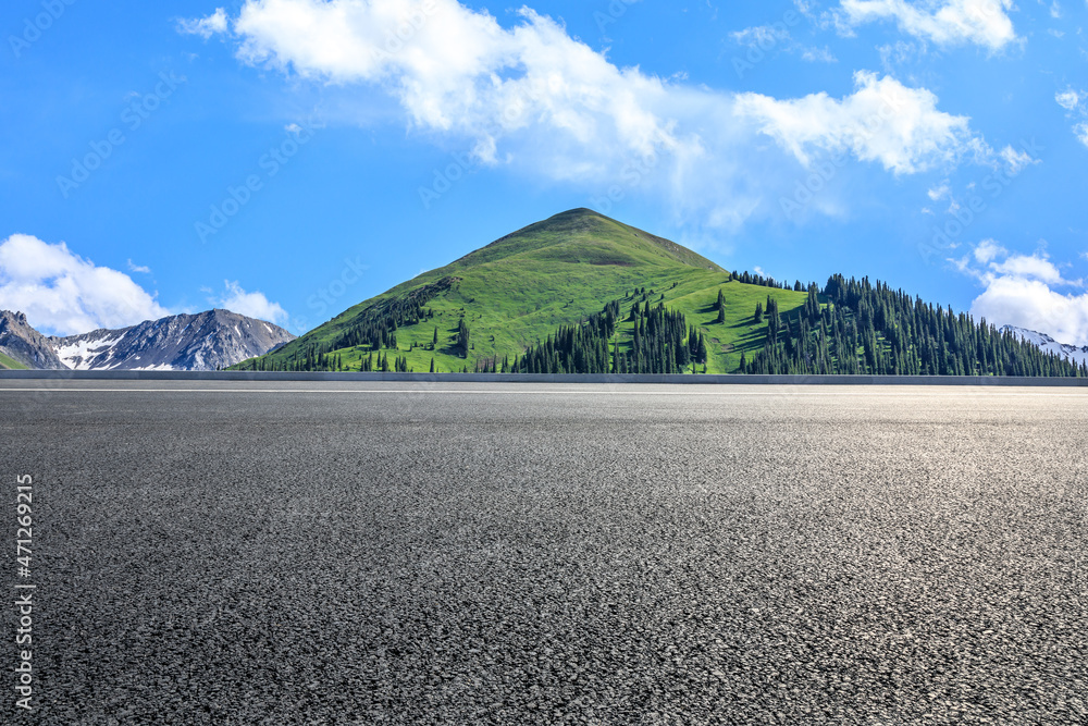 Asphalt road and mountain under blue sky. Highway and mountain background.