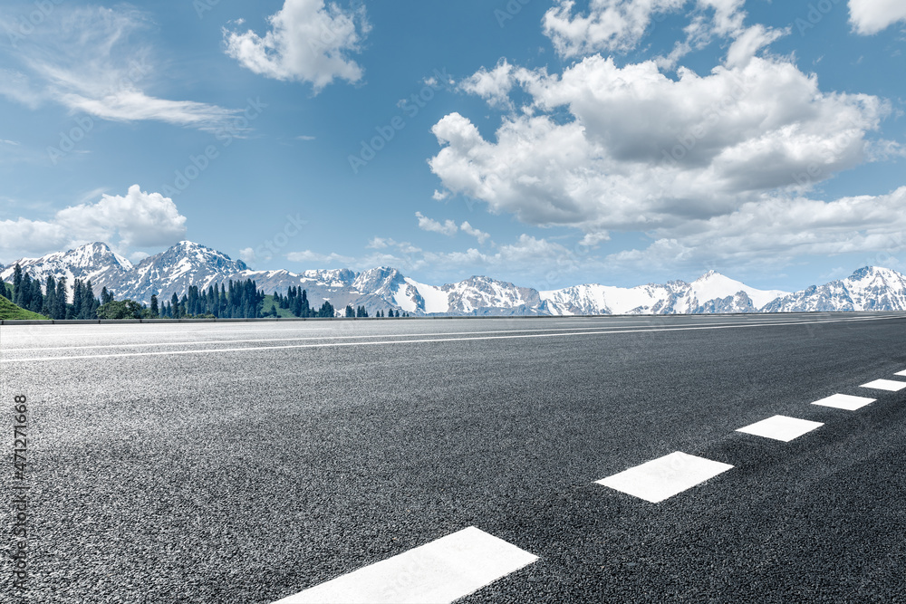 Asphalt road and mountain under blue sky. Highway and mountain background.