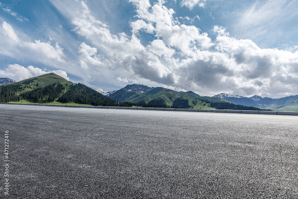 Asphalt road and mountain under blue sky. Highway and mountain background.