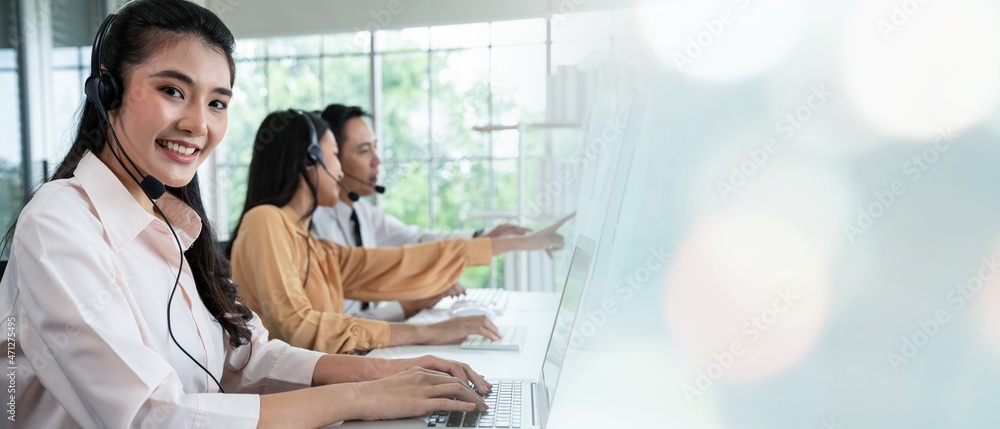 Business team wearing headset working actively in office . Call center, telemarketing, customer supp