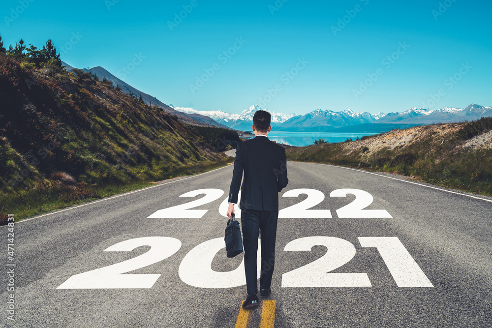 The 2022 New Year journey and future vision concept . Businessman traveling on highway road leading 