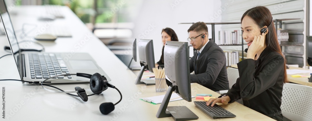 Business people wearing headset working in office to support remote customer or colleague. Call cent