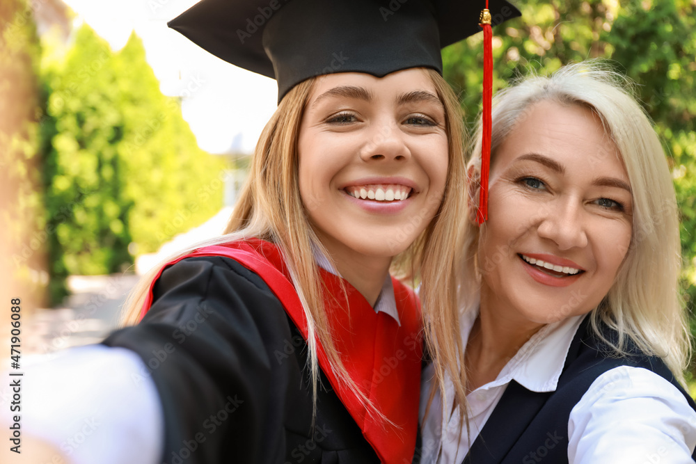 Happy young woman with her mother on graduation day